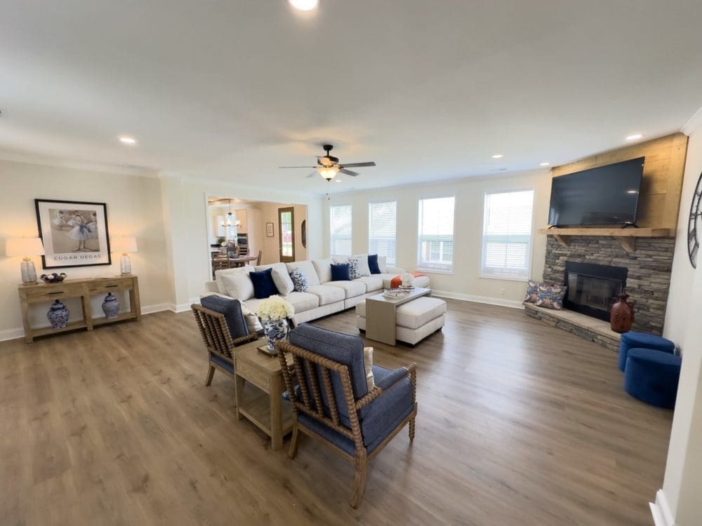 The Riverwalk living room with a closed off kitchen area; showing off the semi open-concept design